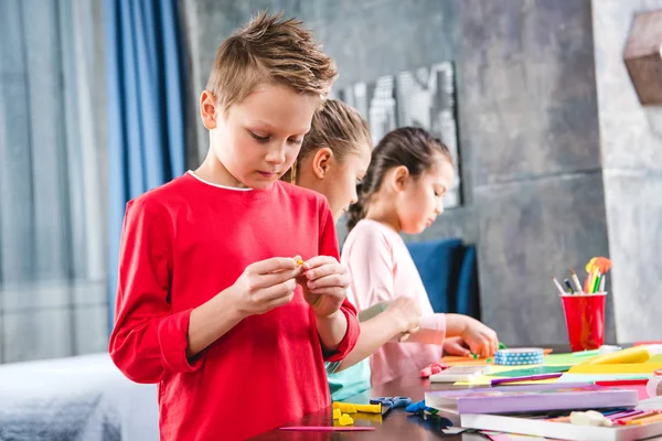 Schoolchildren playing with plasticine — Stock Photo