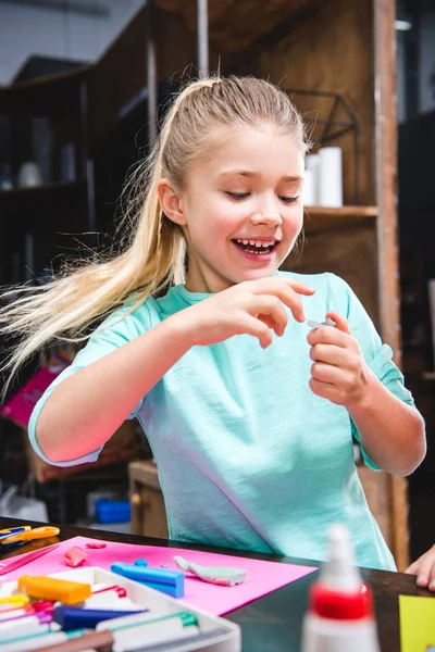 Kid playing with plasticine — Stock Photo