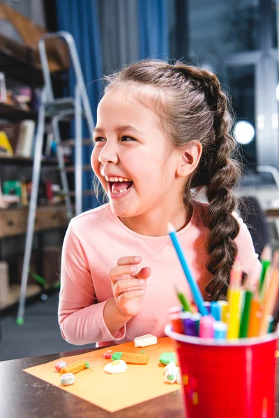 Kid playing with plasticine — Stock Photo
