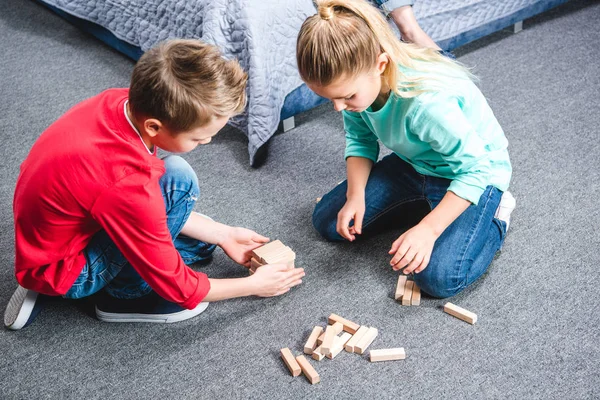 Children playing with wooden blocks — Stock Photo