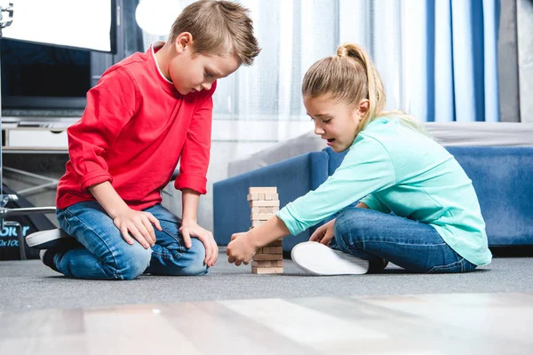 Children playing with wooden blocks — Stock Photo