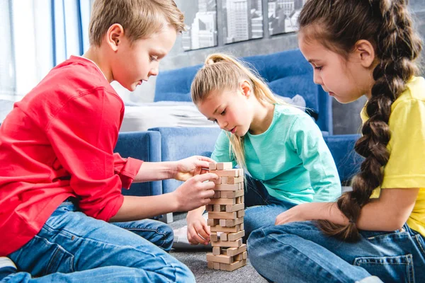 Children playing with wooden blocks — Stock Photo