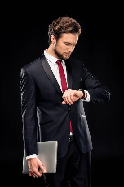 Hombre de negocios guapo sosteniendo portátil - foto de stock