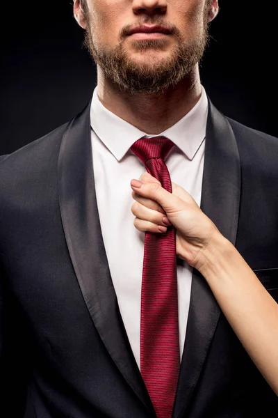 Woman holding businessman by tie — Stock Photo