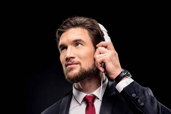 Handsome businessman in headphones — Stock Photo