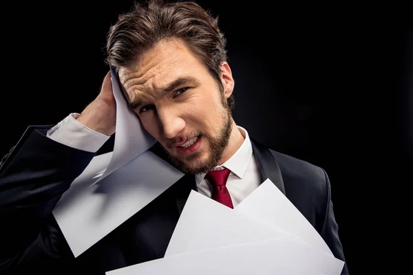 Upset businessman holding papers — Stock Photo