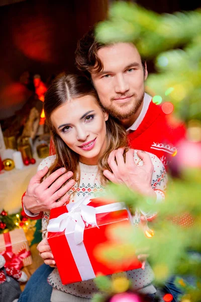 Joyeux couple avec cadeau de Noël — Photo de stock