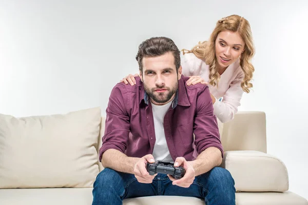 Woman looking at man playing with joystick — Stock Photo