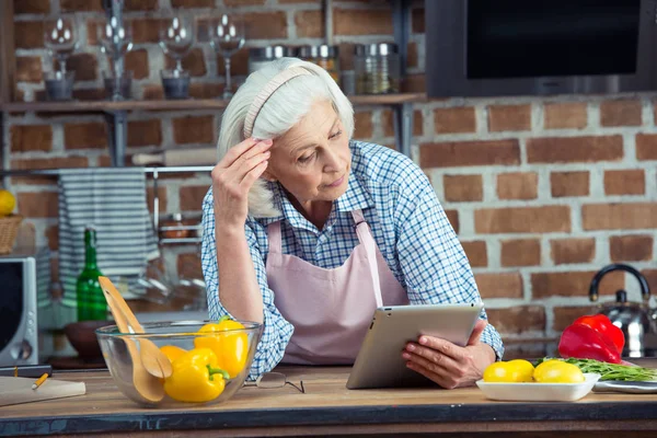 Жінка використовує цифровий планшет на кухні — Stock Photo