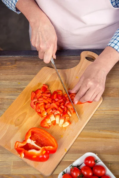 Woman cutting pepper — Stock Photo