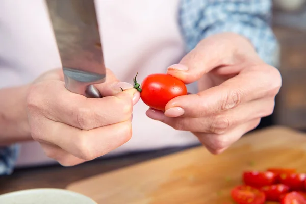 Mujer sosteniendo cuchillo y tomate - foto de stock