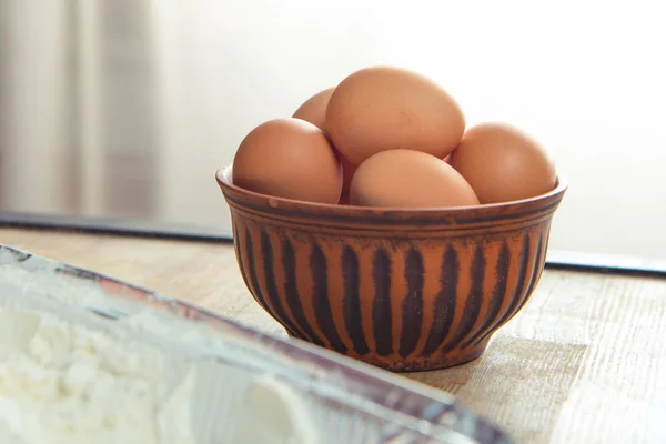 Raw eggs in bowl — Stock Photo