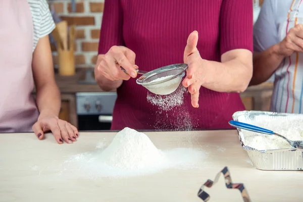 Woman sifting flour — Stock Photo