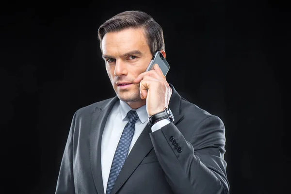 Businessman talking on mobile phone — Stock Photo