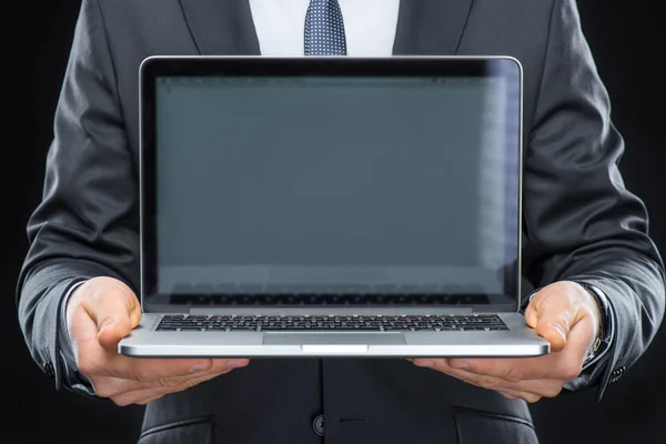Businessman showing laptop — Stock Photo