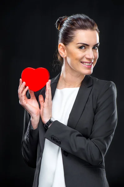 Businesswoman holding red toy heart — Stock Photo