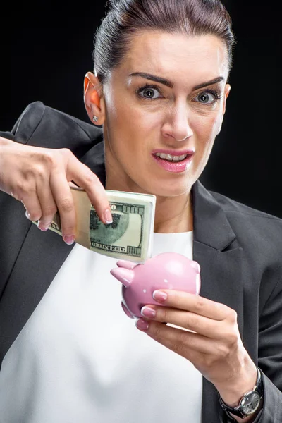 Businesswoman holding piggybank — Stock Photo