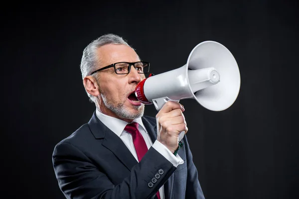 Mature businessman with loudspeaker — Stock Photo