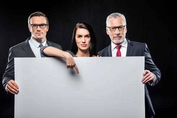 Businespeople holding blank card — Stock Photo