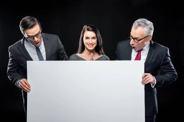 Businespeople holding blank card — Stock Photo