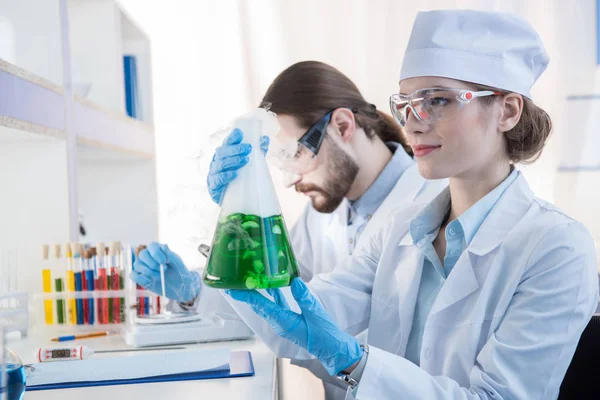 Chemists making experiment — Stock Photo