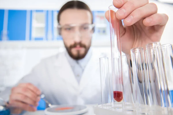 Scientist showing test tube — Stock Photo