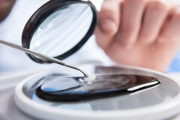 Sample throungh magnifying glass — Stock Photo