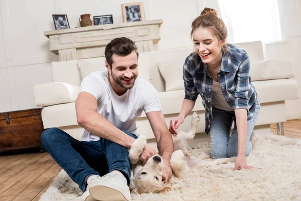 Young couple with puppy — Stock Photo