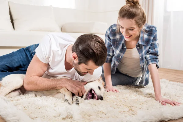Young couple with puppy — Stock Photo