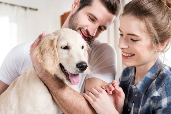 Young couple with puppy — Stock Photo