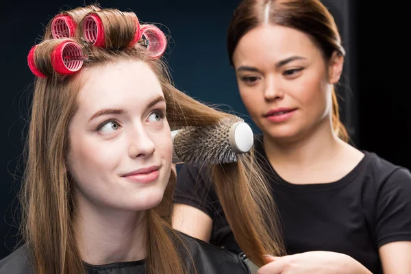 Hairdresser combing hair — Stock Photo