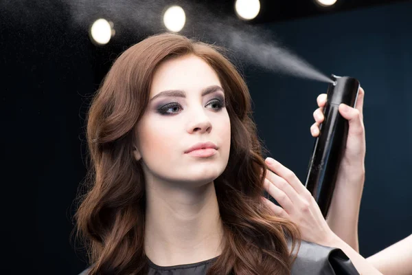 Hairdresser fixing hair of model — Stock Photo