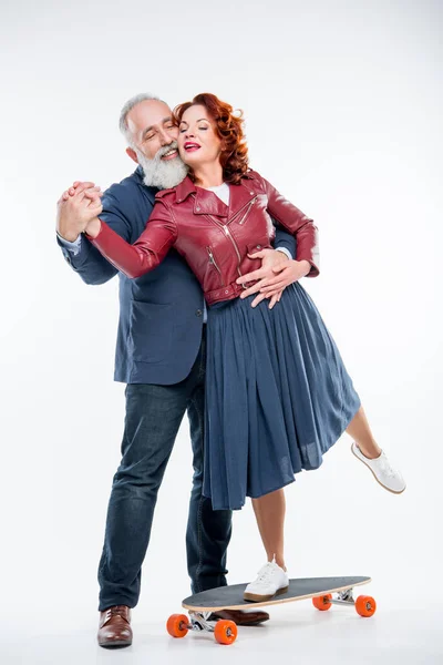 Mature couple with skateboard — Stock Photo