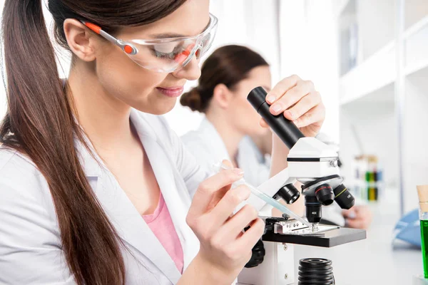 Scientist working with microscope — Stock Photo