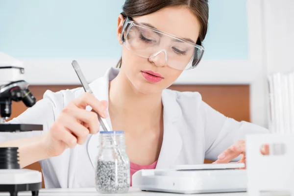 Female scientist in protective glasses — Stock Photo