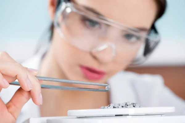 Female scientist in protective glasses — Stock Photo