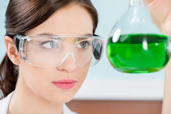 Female scientist in protective glasses — Stock Photo