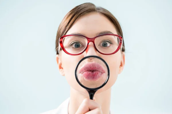 Woman with magnifying glass — Stock Photo