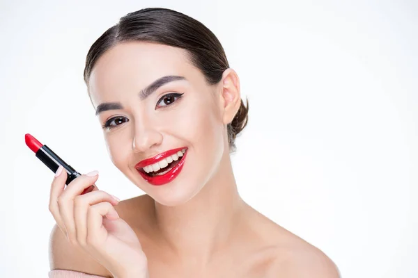 Woman holding red lipstick — Stock Photo