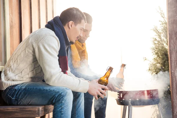 Men holding beer bottles — Stock Photo