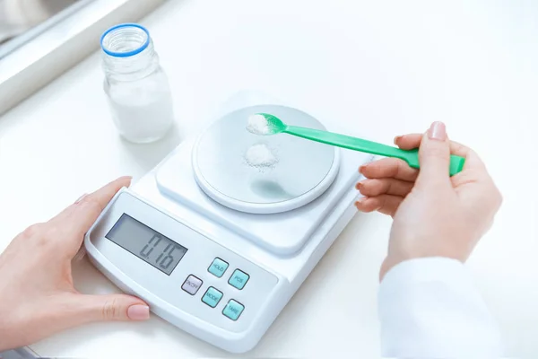 Chemist weighing reagent — Stock Photo