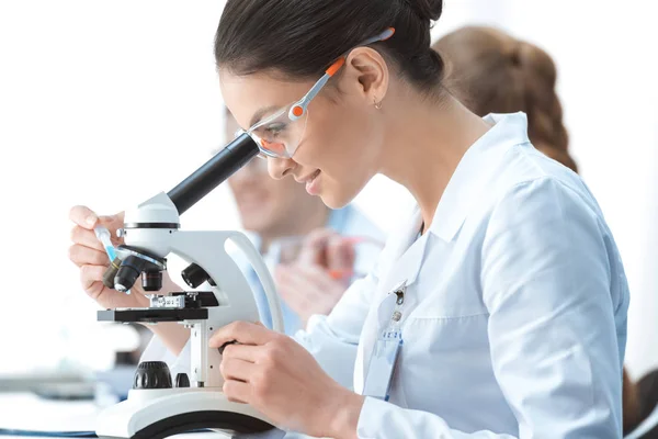 Scientist working with microscope — Stock Photo