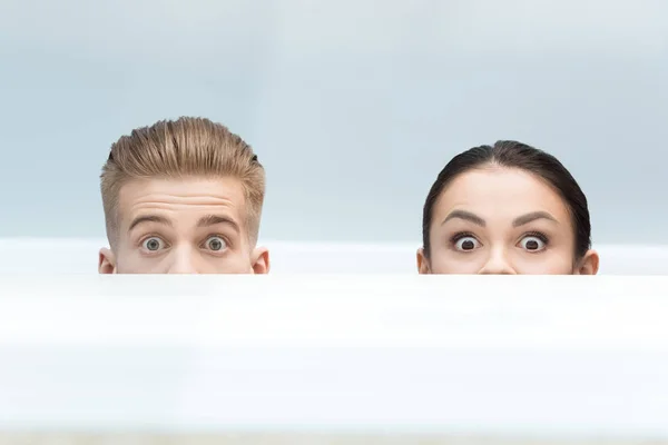 Scientists hiding behind table — Stock Photo