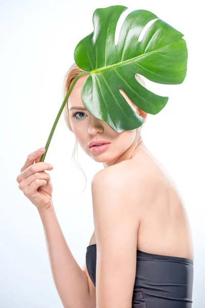 Young woman with green leaf — Stock Photo