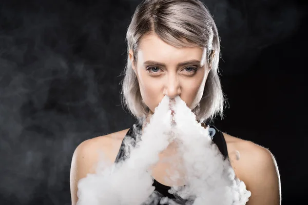 Young woman vaping — Stock Photo