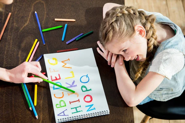 Mother and daughter learning alphabet — Stock Photo