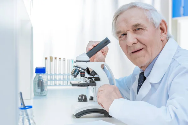 Senior chemists with microscope — Stock Photo
