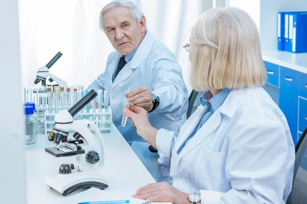 Senior chemists with test tube — Stock Photo