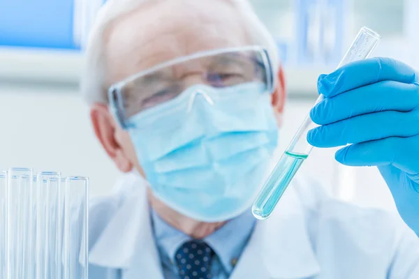 Senior chemist with test tube — Stock Photo