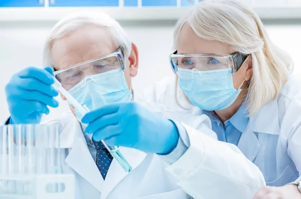 Senior chemists with test tubes — Stock Photo